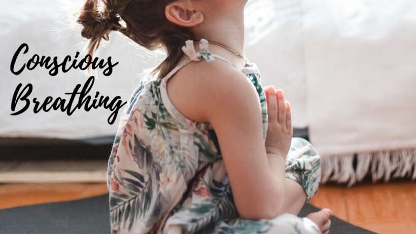 Girl meditating, eyes closed, hands in prayer position.