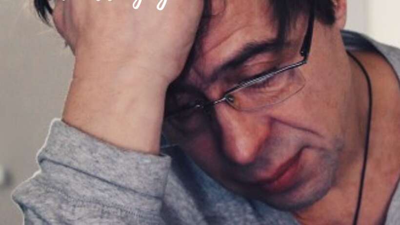 Man stressed, hand on head. Emotions controlling him?