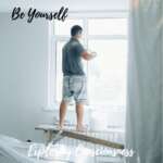 Man painting window with 'Be Yourself' text.