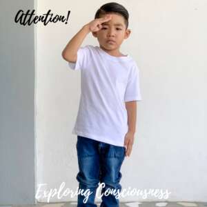 Boy in white tee saluting.