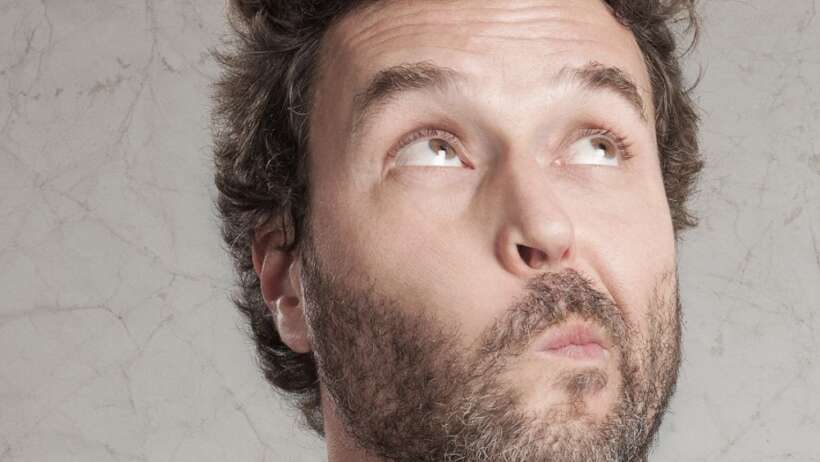 Man looking upwards, facing uncertainty and exploring consciousness.