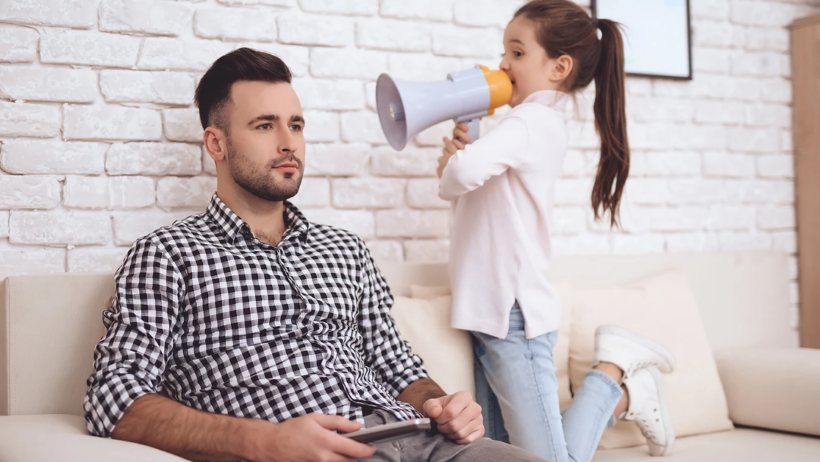 Daughter with megaphone 'speaking' to her dad.