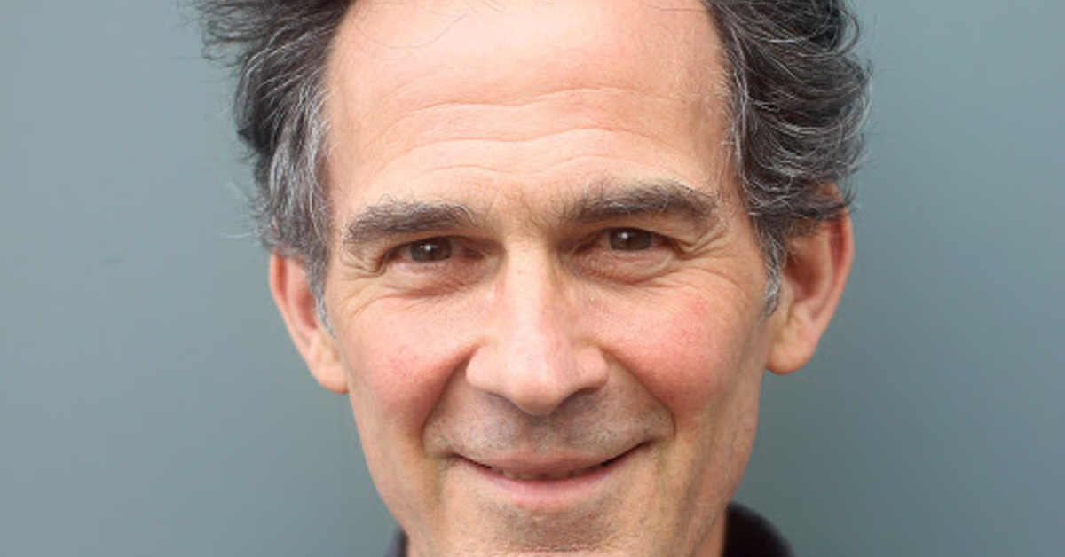 Close-up portrait of a smiling man, UK.